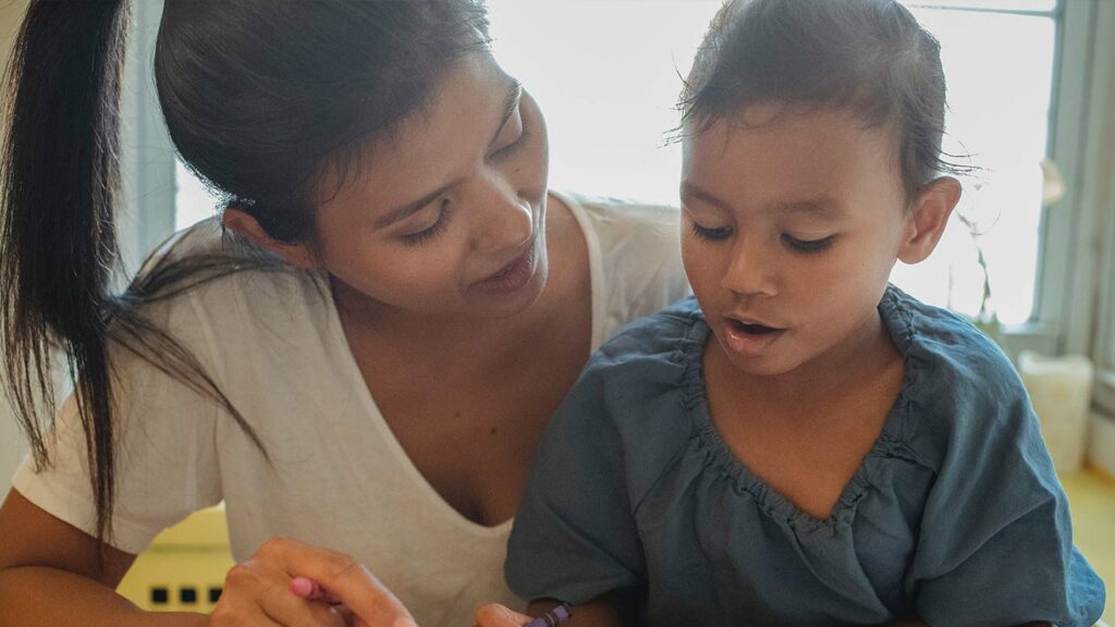 Teacher giving help to a student
