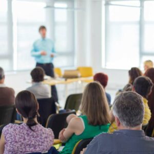 Instructor at a training course standing in front of attendees