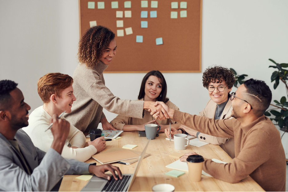 A group of individuals in a workspace working together and agreeing on a plan